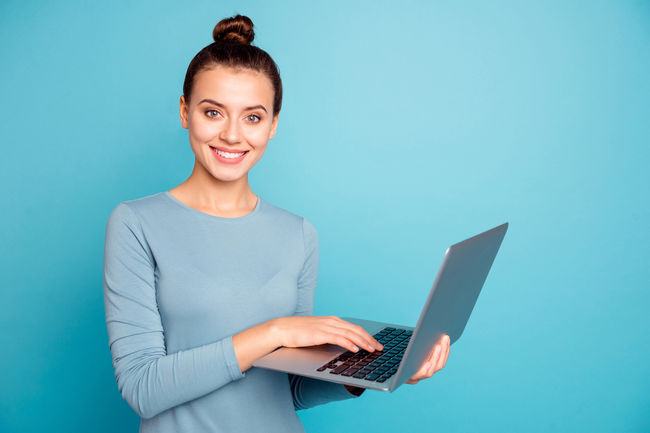 Portrait of youngster have modern technology satisfied candid content search news feed apps programs devices dressed modern cotton clothing isolated on blue background.